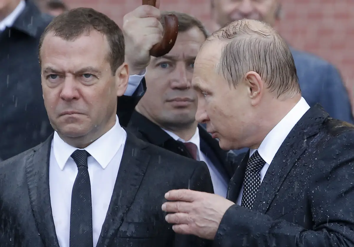 Prime Minister Dmitry Medvedev stands in the rain next to Putin during the same wreath-laying ceremony marking the anniversary of the Nazi German invasion at the Kremlin wall in Moscow, Russia on June 22, 2017.
